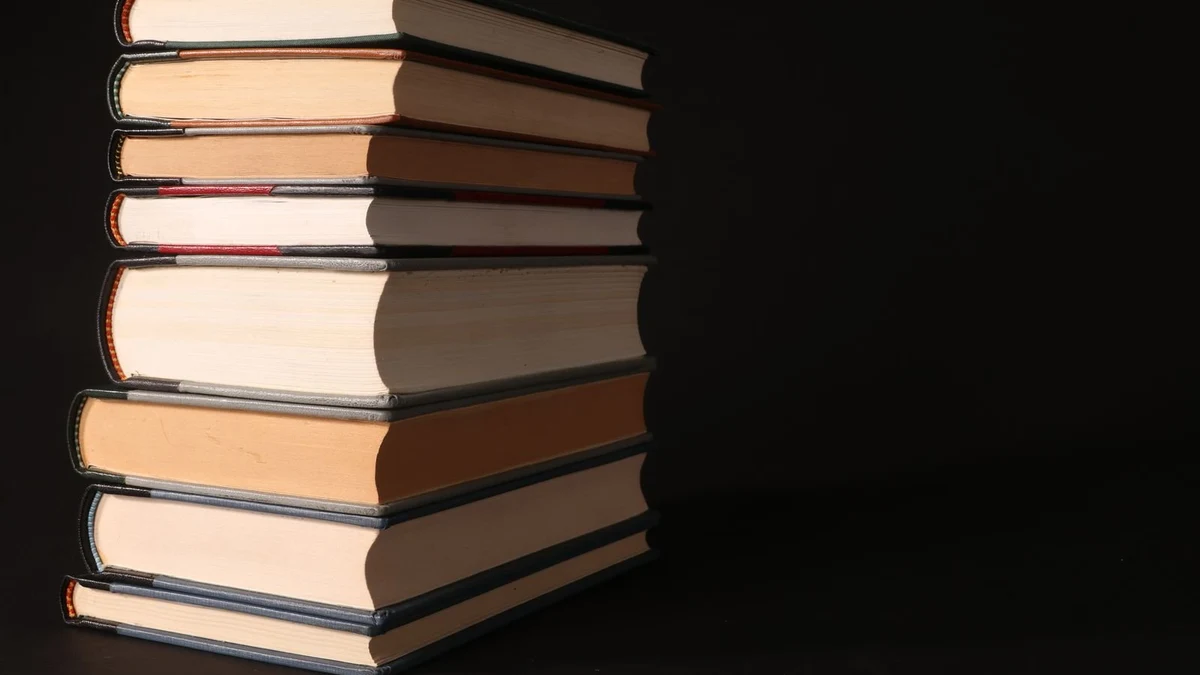 A stack of well-worn study books on a student&rsquo;s desk