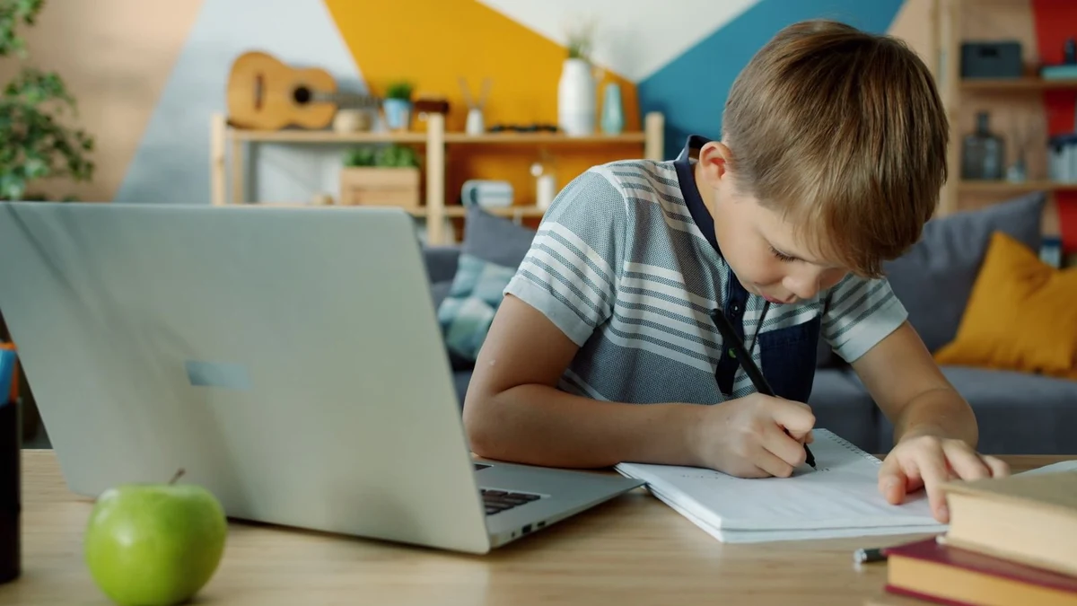Mother helping her young child study calmly at home